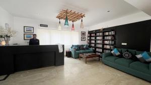 a man standing at a counter in a living room at Gomang Boutique Hotel in Leh