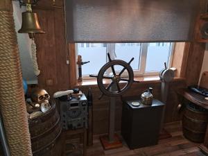 a room with a steering wheel and a window at Yacht Club in Liepāja