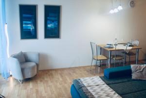 a living room with a couch and a table and chairs at JASMINE APARTMENT - FREE PARKING - CITY CENTER - SKIBUS - TATRALANDIA 5km in Liptovský Mikuláš