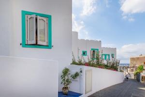 um edifício branco com uma janela e plantas sobre ele em Stromboli Trekking Accommodation - Room and Excursion for 2 included em Stromboli