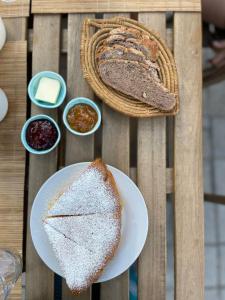 a table with two slices of bread and some condiments at B&B San Gregorio SINNAI in San Gregorio +39 photos