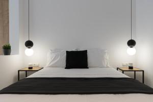 a bedroom with a bed with two side tables at Voda Luxury Residence #401 in Athens