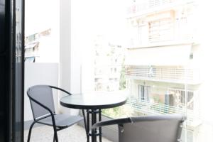 a table and two chairs in front of a window at Voda Luxury Residence #401 in Athens