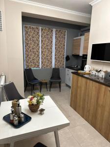 a kitchen and living room with a table and chairs at City centre stylish apartament with private backyard in Sofia