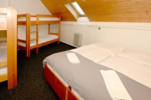 a small room with two bunk beds and a window at Horská Chata Sabinka in Malá Morávka