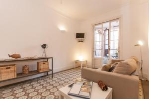 a living room with a couch and a table at Weflating Sant Antoni Market in Barcelona