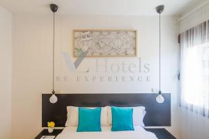 a bedroom with a bed with blue and white pillows at AYZ Villegas - Auto check-in property in Madrid