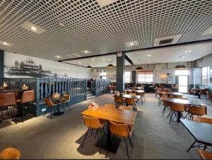 a restaurant with tables and chairs in a room at LA07 Oceanview in Morecambe