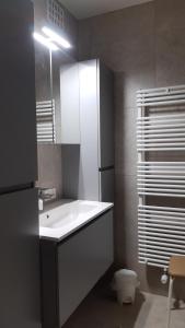 a bathroom with a white sink and a toilet at a'Mare - Valparaiso Koksijde in Koksijde +22 photos