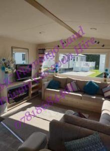 a living room with purple writing on the wall at Flamingo Land - Woodlands W174 in Kirby Misperton