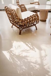 a shadow of a chair and a table in a room at Palmyard Hotel in Manama