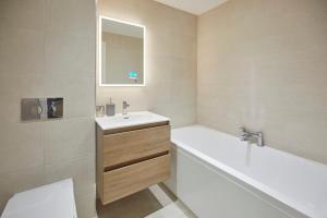 a bathroom with a tub and a sink and a bath tubermottermott at Host & Stay - Rest Assured in Whitby