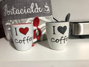 two coffee mugs with hearts on them sitting on a counter at LamaisondeMaria in Carpinone