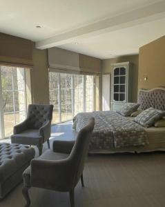 a large bedroom with a bed and a chair at Château de Cachard in Boffres +44 photos