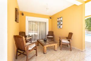 sala de estar con sillas, mesa y mesa en Villa lussuosa a 1,5 chilometri da Costa Adeje, en Adeje