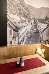 a room with a bed and a view of a city at Landgasthof Hirschen in Hohenems