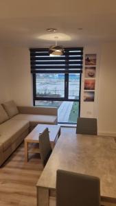 a living room with a couch and a table at Lovely Super Luxury One Bed Apartment 216 in Luton