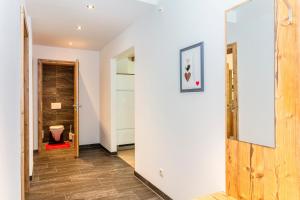 a hallway with a door leading to a bathroom at Eberharthof in Saalbach-Hinterglemm +95 photos