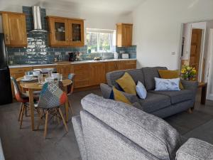 a living room with a couch and a table at Woodland Lodge in Lisnaskea