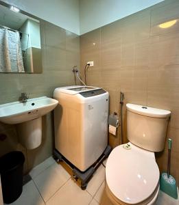 a bathroom with a toilet and a sink at Victoria’s Place in Manila