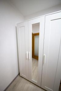 a white wardrobe in a room with a mirror at 2 Zimmer mit Netflix, Prime, Küche, Bad in Seenähe in Unterwellenborn