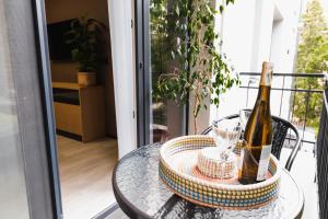 a table with a bottle of champagne on a balcony at Miracle Place in Ivano-Frankivsk