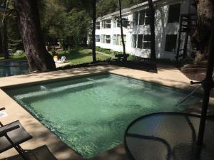 a swimming pool in front of a house at Hotel Robledal in Las Trancas