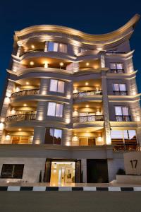 a large building with lights on it at night at Parkside Boutique Serviced Apartments in Cairo