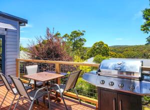 a patio with a table and a grill on a deck at Elroma, a grand Federation house in Hepburn Springs in Hepburn Springs