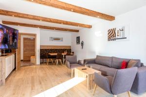 a living room with a couch and a table at Eberharthof in Saalbach-Hinterglemm
