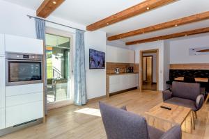 a kitchen and living room with a table and chairs at Eberharthof in Saalbach-Hinterglemm
