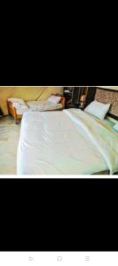 two pictures of a large bed with white sheets at Rum titanic camp in Wadi Rum