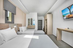 a bedroom with a bed and a living room at NewStory Luxury Suites Possidi in Possidi