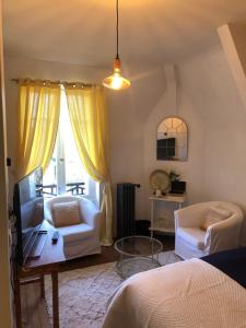 een slaapkamer met een bed, een bank en een tafel bij Maison de la Comtesse in Cosne-dʼAllier