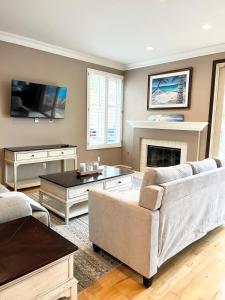 a living room with a couch and a fireplace at Casa Oasis/Pool & Jacuzzi/4 Bedroom/ Wi-Fi in Camarillo