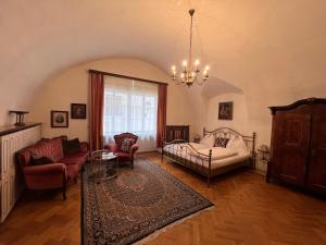 a living room with a bed and a couch at Hotel Gasthof Kohlmayr in Gmünd in Kärnten