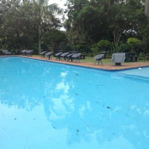 a large swimming pool with chairs and a table at For your family Manzini 1 in St Lucia