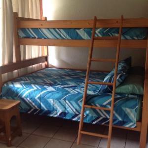 a bunk bed with a ladder in a room at For your family Manzini 1 in St Lucia