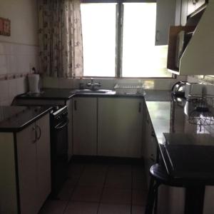a small kitchen with a sink and a window at For your family Manzini 1 in St Lucia