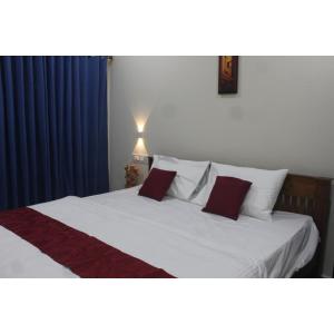 מיטה או מיטות בחדר ב-Nature Villa Kochi
