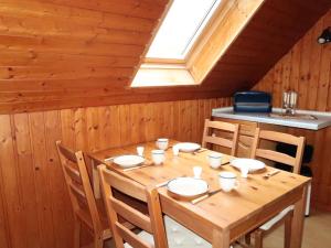 einen Holztisch in einem Zimmer mit Dachfenster in der Unterkunft Apartment Hannemann-1 by Interhome in Schillig