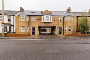 a large brick building with a garage at TM - Rana Court 1 Bedroom apartment with balcony in Oxford