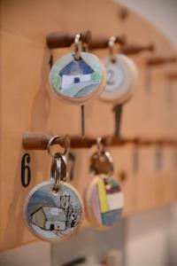 a group of key rings hanging from a wall at Garni Appartements Almrausch in Burgusio