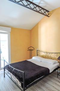 Un dormitorio con una cama negra con paredes amarillas en Holiday Home LA FORGE by Interhome, en Saint-Pandelon