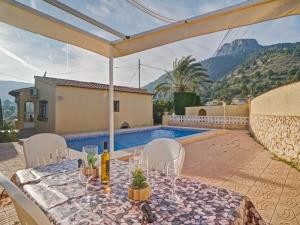 a patio with a table and chairs and a pool at Holiday Home Villa Servinola by Interhome in Calpe