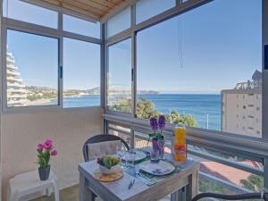 jadalnia ze stołem i widokiem na ocean w obiekcie Apartment Horizonte-6 by Interhome w mieście Calpe