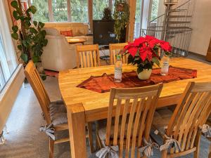 a wooden table with red flowers in a living room at Chalet Christine by Interhome in Molberting
