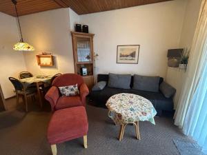 a living room with a couch and a table at Apartment Dehne-2 by Interhome in Norddeich
