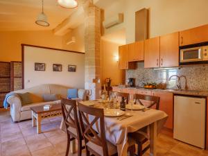 a kitchen and living room with a table and chairs at Apartment Agroturismo Roqueta - MDS101 by Interhome in Maria de la Salut