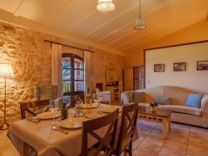 a dining room with a table and a couch at Apartment Agroturismo Roqueta - MDS101 by Interhome in Maria de la Salut